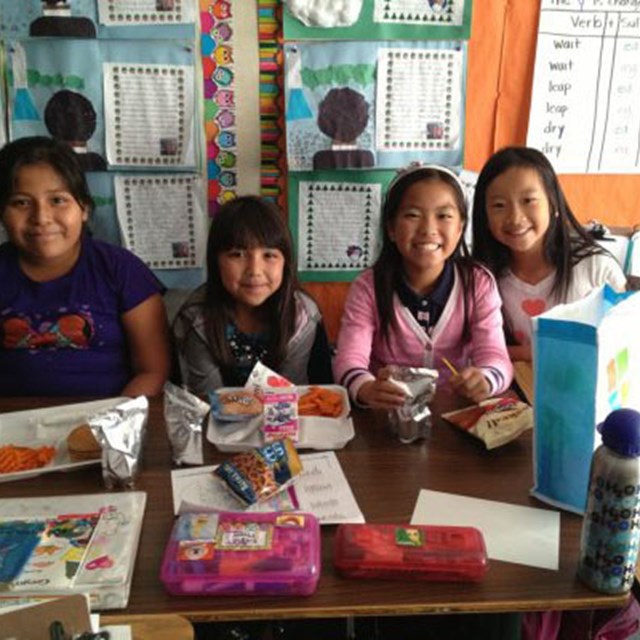 Students enjoy their lunch inside the classroom.