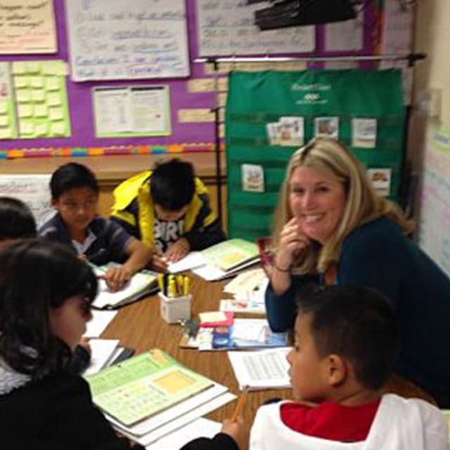 A Carrillo teacher helps her students with math problems.