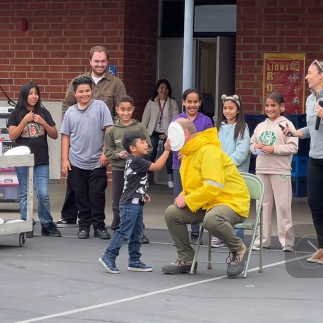 Students earning their PBIS monthly prize, PIE the Principal!